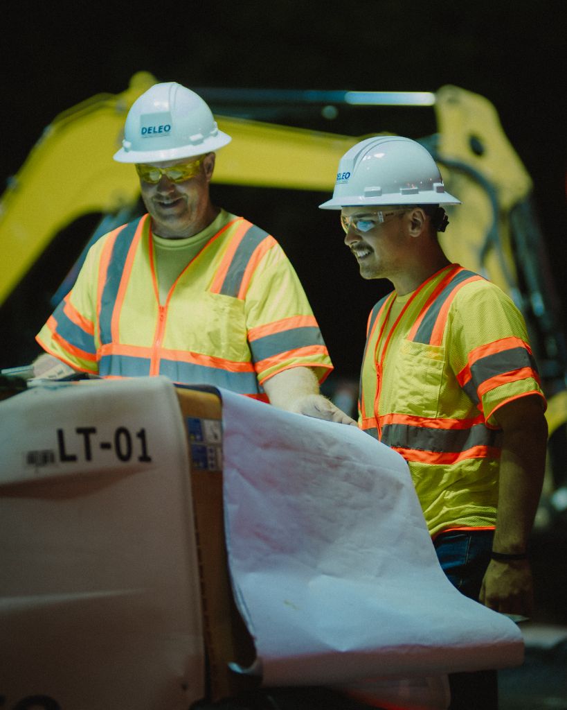 DeLeo crew reviewing plans at night job site